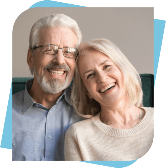 Older couple with dentures smiling.