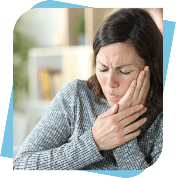 Woman holding her cheek because of tooth pain.