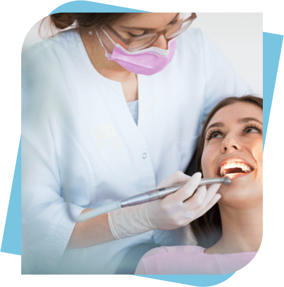 Woman looking up at dentist and smiling while having work done.