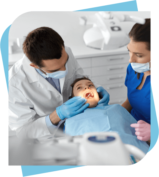 Dentist and assistant checks a child's mouth.