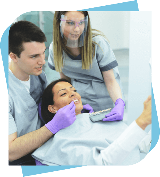 Dentist and Assistant check tooth colour to pick out veneers.