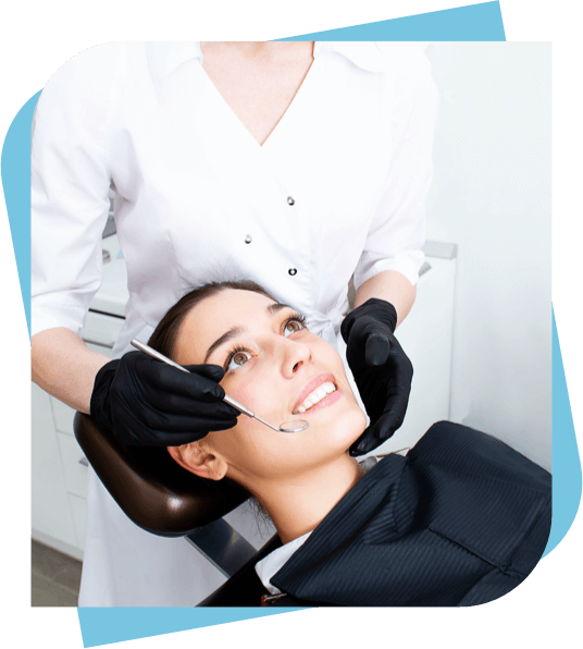 Woman in a dental chair looking up while the dentist begins her examination.