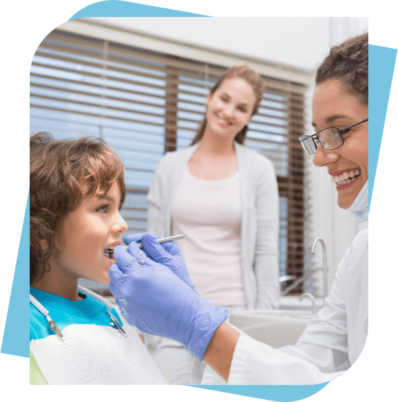 Dentist checks out a child's teeth while his mom looks on.