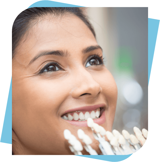 Woman smiling infront of a display of porcelain inlays