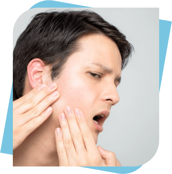 Man massaging his jaw to relieve pain.