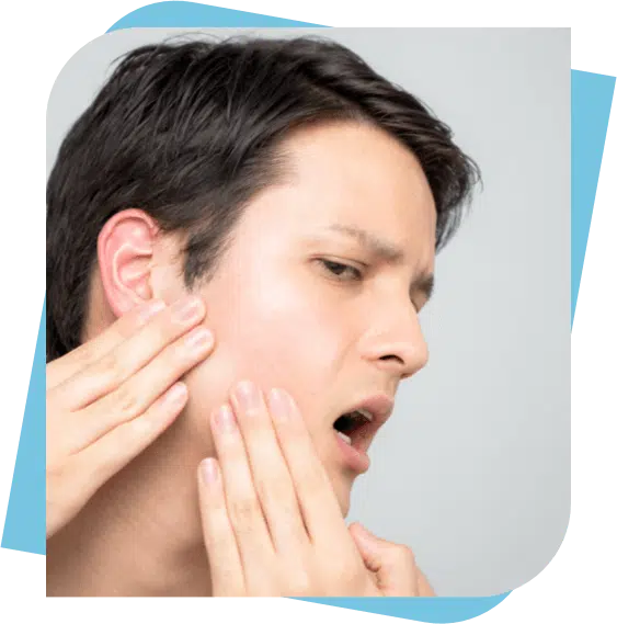 Man massaging his jaw to relieve pain.