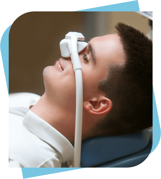 Man with a nasal gas mask being sedated before dental work.