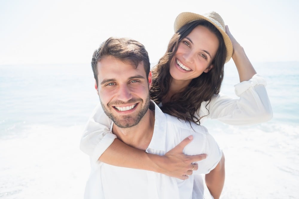 happy couple smiling nicely thanks to cosmetic dentistry