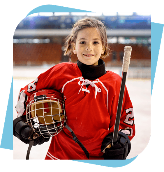 Young female hockey player holding her stick and helmet
