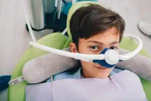 young kid receiving nitrous oxide sedation during dentist appointment