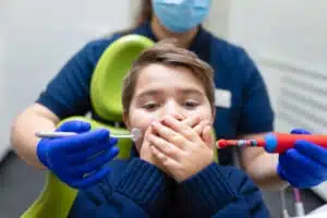 young boy worried about being at the dentist