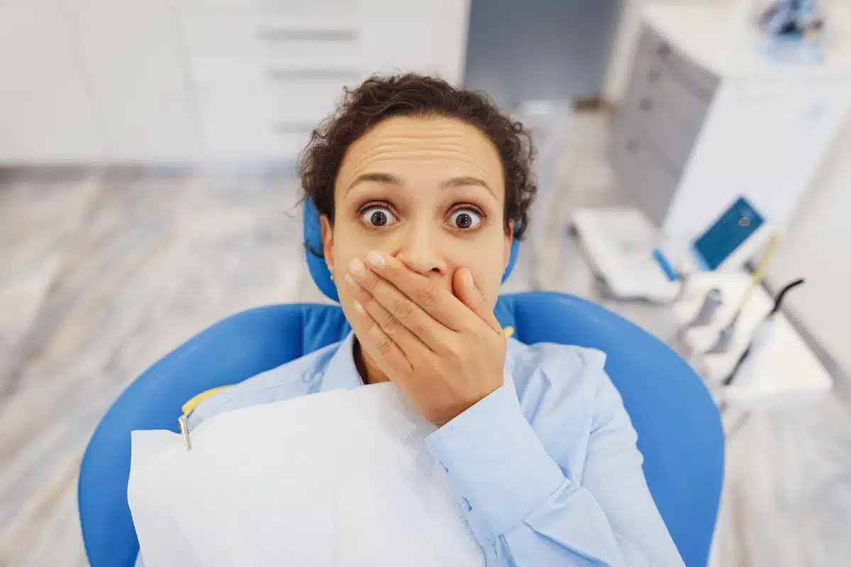 woman nervous about dental treatment while sitting in dental office