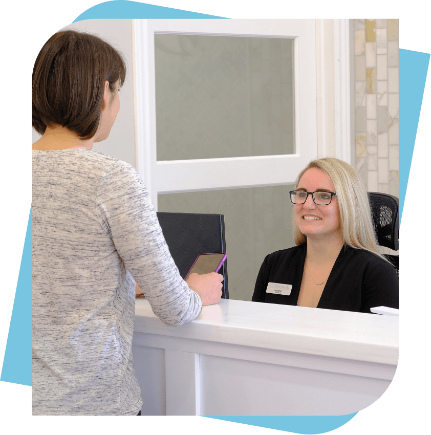 Receptionist smiling at client